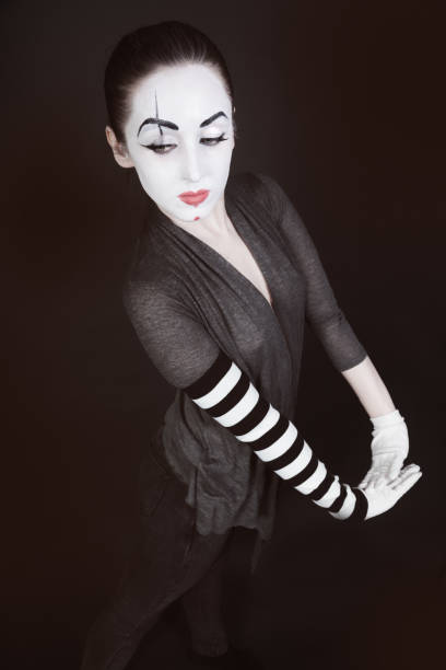 istock female mime in  gray jacket on  black background 654089902