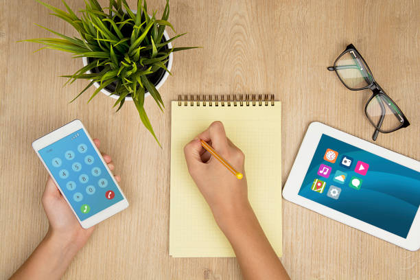istock Women phone calls and taking notes 654090540