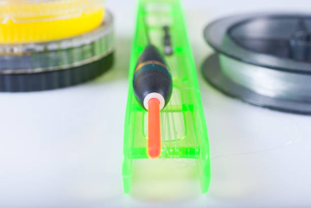 istock Accessories for fishing. Float, fishing line and a box. Focus on the float 654091668