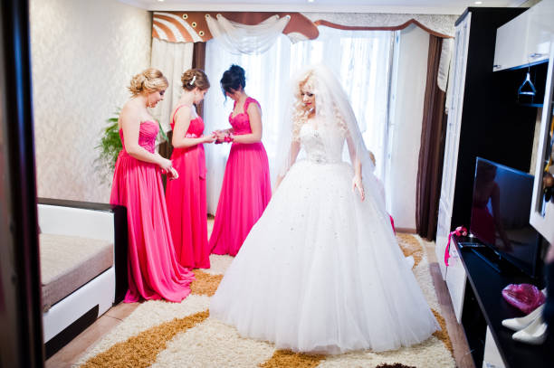 istock Pretty blonde bride with four magic bridesmaids having fun at room 654094278
