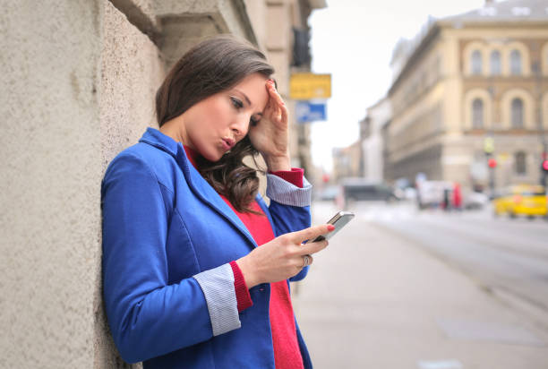 istock Woman is texting on the street 654094296