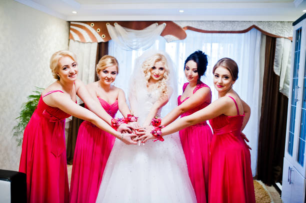 istock Pretty blonde bride with four magic bridesmaids posing at room 654094470