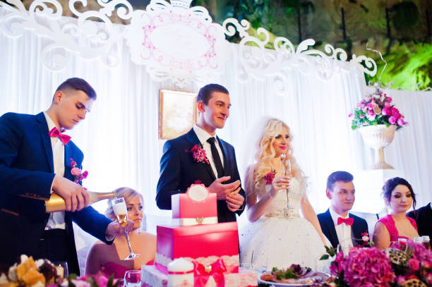istock Wedding couple with friends at wedding table 654098424