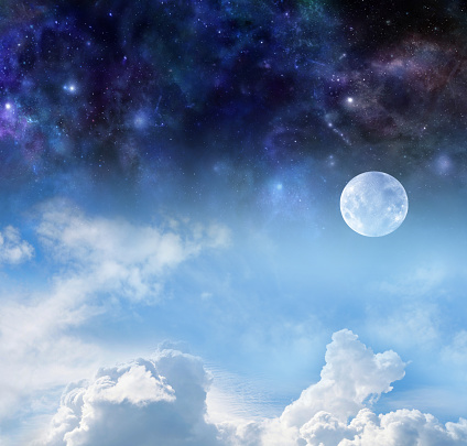 The pale moon with blue sky and fluffy clouds below and deep space night sky above with plenty of copy space