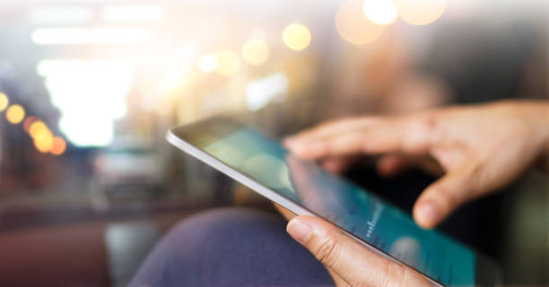 Businessman using tablet at night time Businessman using tablet at night time company news stock pictures, royalty-free photos & images