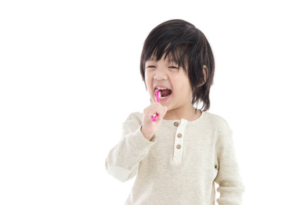 istock Cute asian boy brushing teeth on white background isolated 654103454
