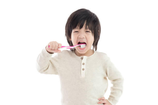 istock Cute asian boy brushing teeth on white background isolated 654103456