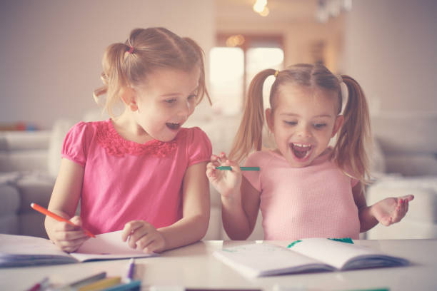 istock Cute little girls drawing. 654106756