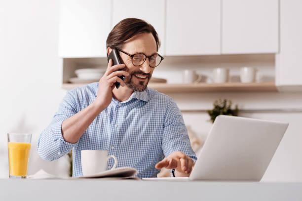 istock Delightful mature freelancer enjoying working at home 654106786