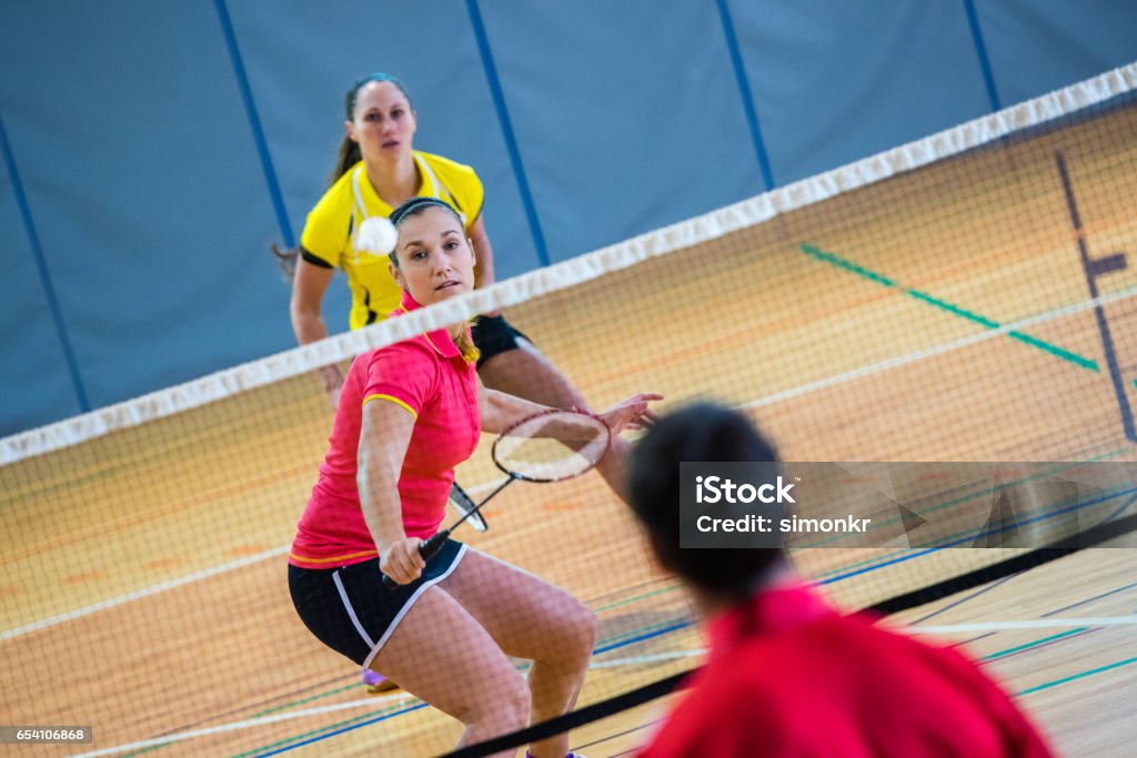 Badminton mixed doubles Male and female players in badminton mixed doubles match. Badminton - Sport Stock Photo
