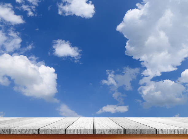 istock wooden tabletop with summer sky background 654107810