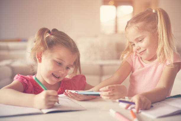 istock Cute little girls drawing. 654108580