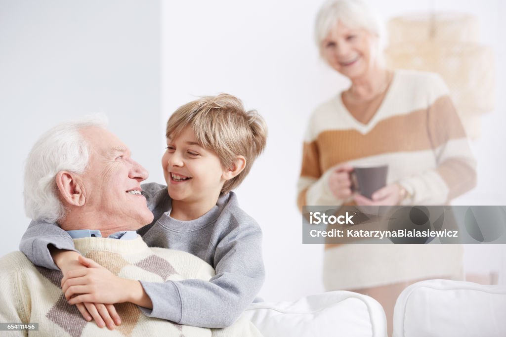 Boy embracing his grandfather Grandmother and happy boy embracing his beloved grandfather Grandfather Stock Photo