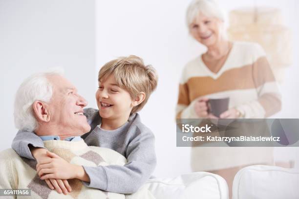 Boy Embracing His Grandfather Stock Photo - Download Image Now - Grandfather, Embracing, Grandson