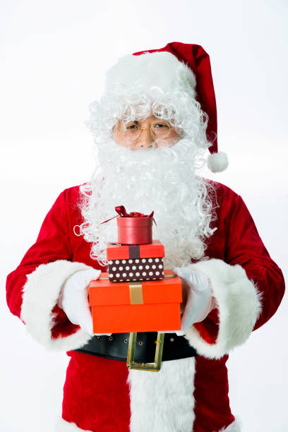 santa claus holding sack of presents isolated on white background.