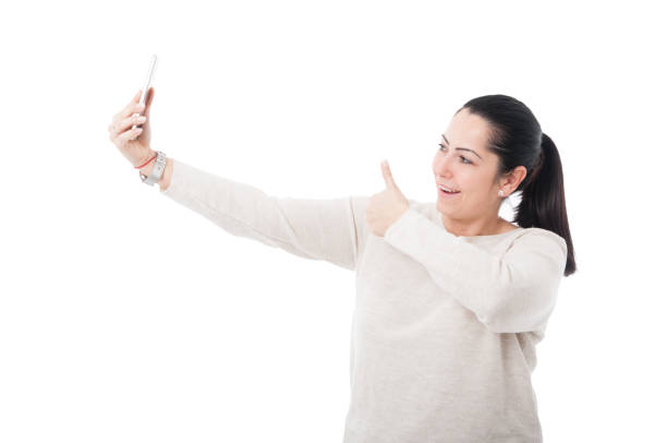 istock Pretty female posing joyfully at her smartphone 654112752