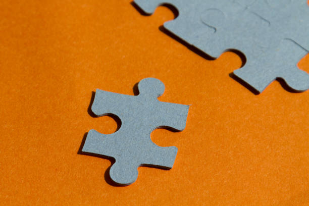 istock Jigsaw puzzle pieces on bright orange background 654112776