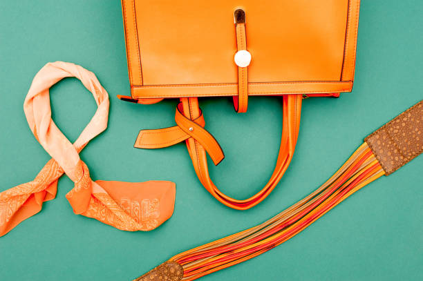 istock Orange Accessories On Emerald Green Background 654112966
