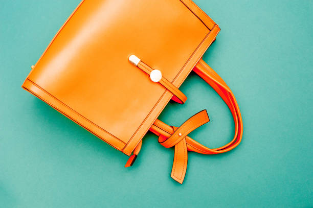 Orange Handbag On Emerald Green Background