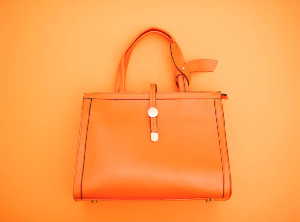 istock Orange Handbag On Orange Background 654113180