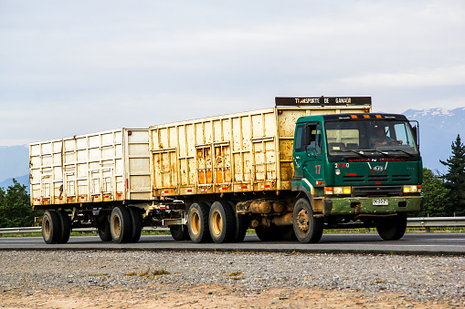 O'Higgins, Chile - November 19, 2015: Trailer truck Nissan Diesel at the interurban freeway.