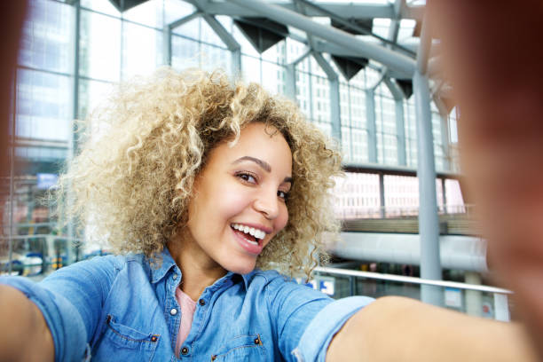 istock Smiling young african american woman taking selfie 654123072