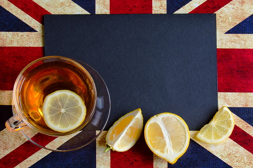 Black copy space for your text on background of British flag with a cup of lemon tea