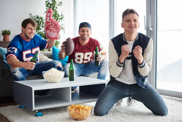 young men watching american football competition - american football football food snack imagens e fotografias de stock