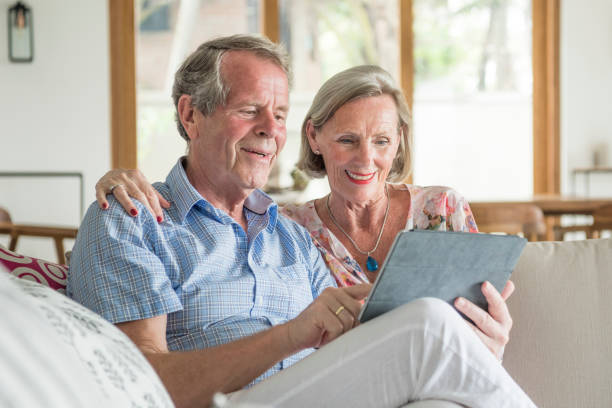 istock Senior man using tablet, woman with hand on shoulder 654133754