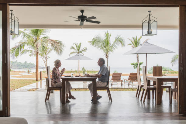 Senior couple sitting at table eating meal