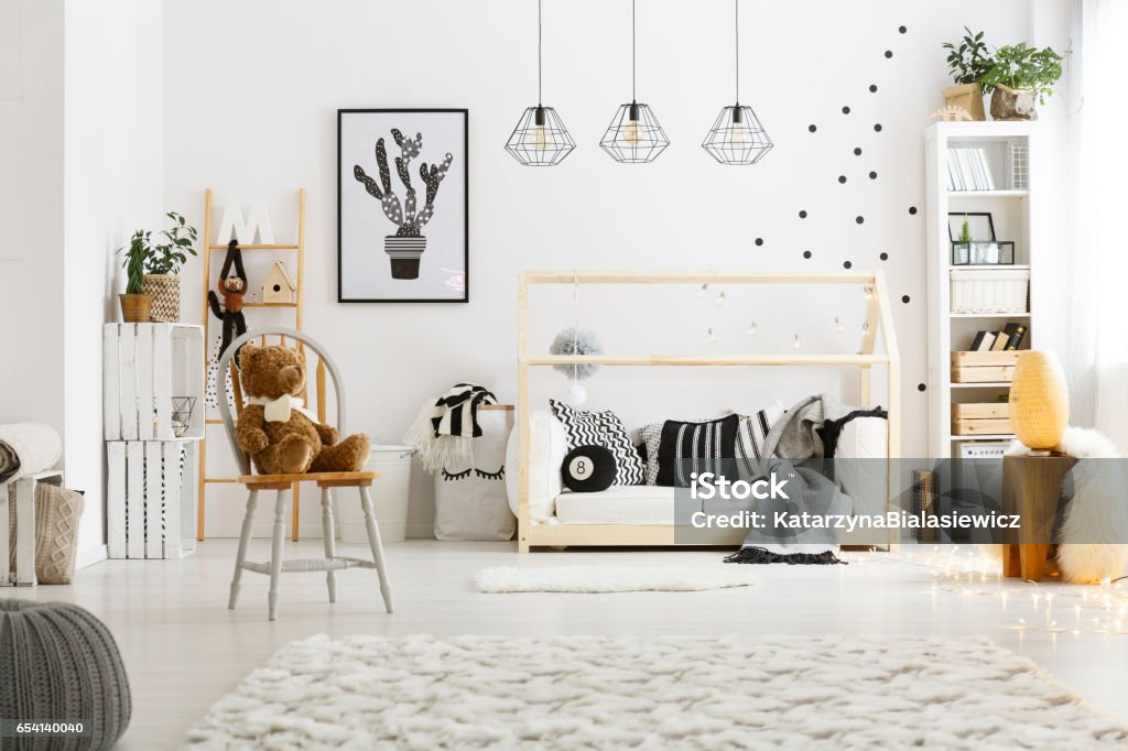 White child bedroom with carpet White child bedroom with carpet, pouf, chair, bed and bookcase Child Stock Photo