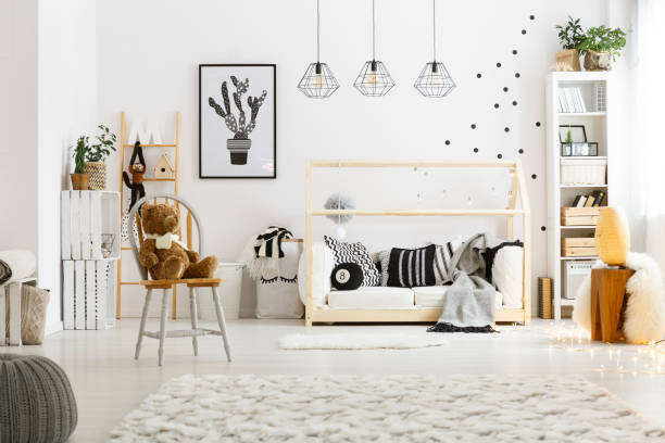 White child bedroom with carpet White child bedroom with carpet, pouf, chair, bed and bookcase nursery bedroom stock pictures, royalty-free photos & images