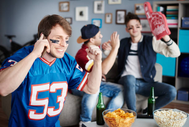 istock Top view of sports fan using cell phone 654140322