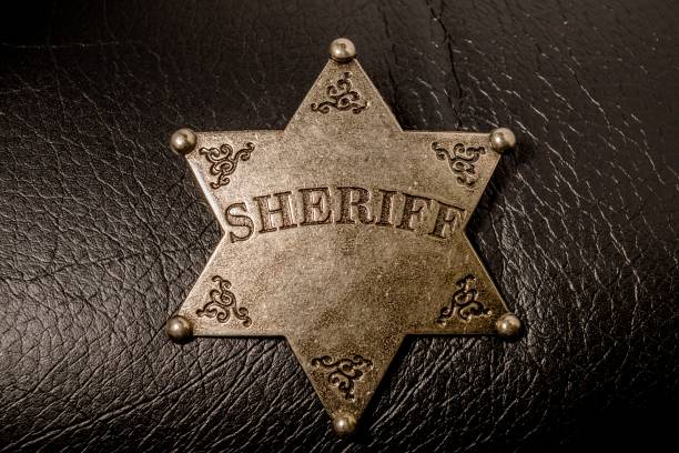 istock Sheriff badge on black leather texture background. 654140476