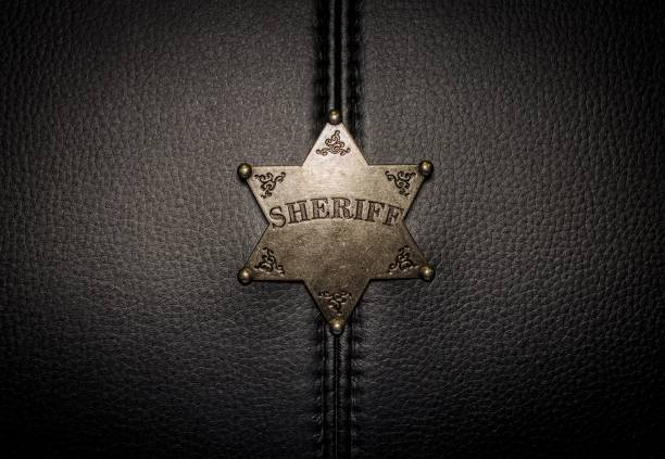 istock Sheriff badge on black leather texture background. 654140488
