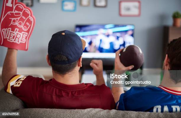 Two Men With Foam Hand And Baseball Equipment Stock Photo - Download Image Now - Watching, Soccer, Soccer Ball