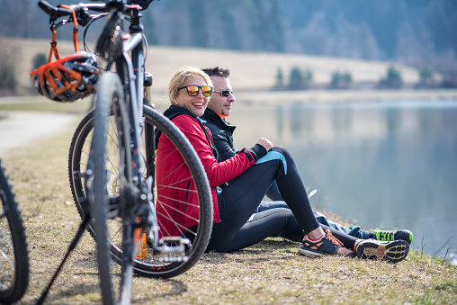 A couple taking a short break during cycling outdoors and admiring the view