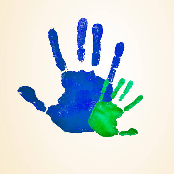 istock adult and infant handprints 654152252