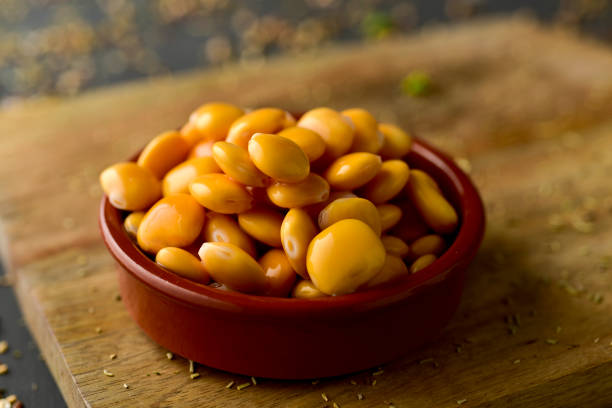 closeup of an earthenware bowl full of altramuces, lupinus albus beans traditionally eaten as snack in Spain, and also in Portugal and Italy, where are known as lupini and tremocos, respectively