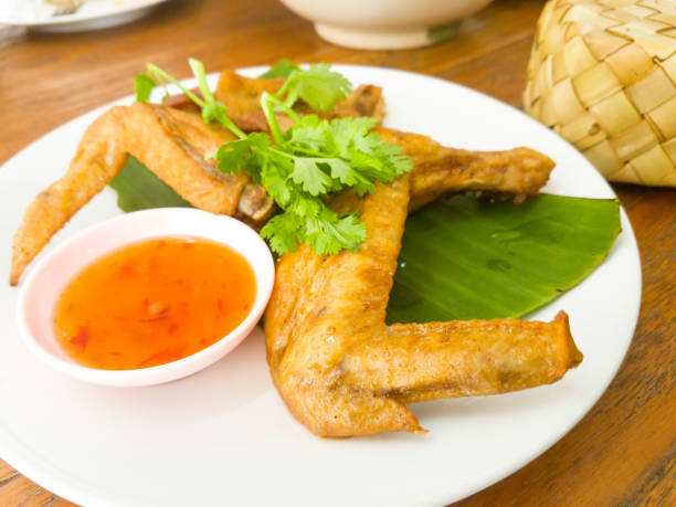 istock Fried chicken wings and sauce on white dish 654153192