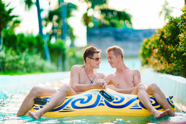 Homosexual couple having fun in waterpark