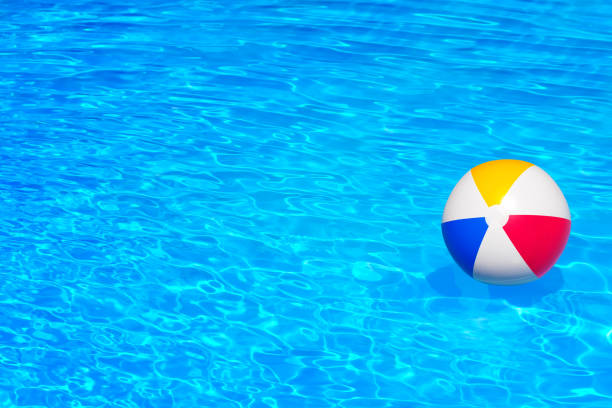 istock Colorful inflatable ball floating in swimming pool 654161808