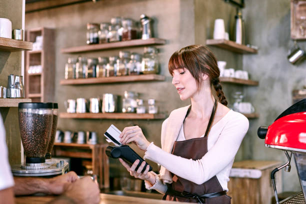 istock Staff Serving Customer In Busy Coffee Shop 654162198