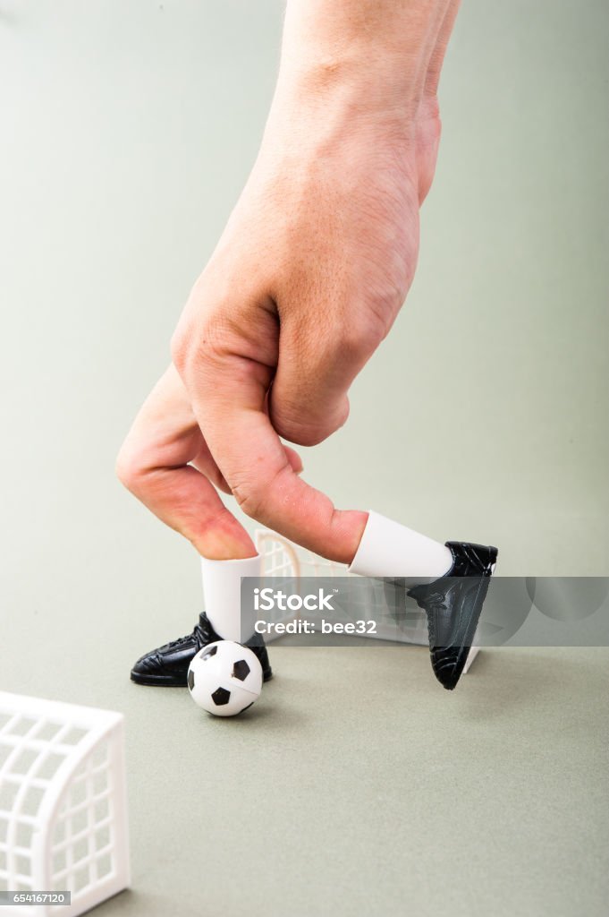 Miniature football game with human fingers Human Body Part Stock Photo