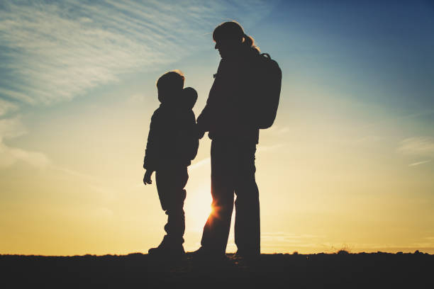 istock mother and little son travel at sunset 654168032
