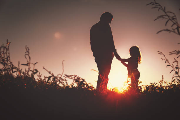 istock father with little daughter walk in sunset 654174760