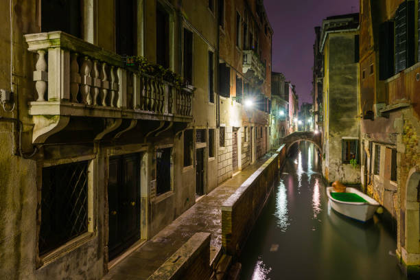 istock Venice quiet canals alleyways illuminated by lamplight at night Italy 654177864