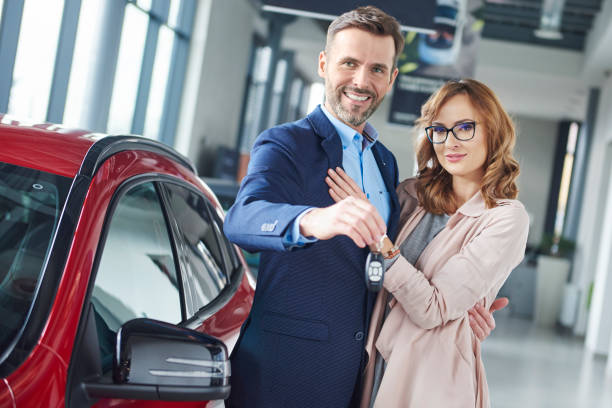 istock Couple with car keys next to their new vehicale 654180722