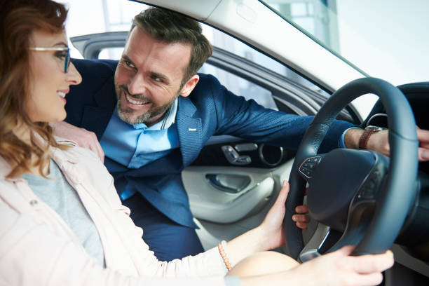 istock Couple checking out new car interior 654180942