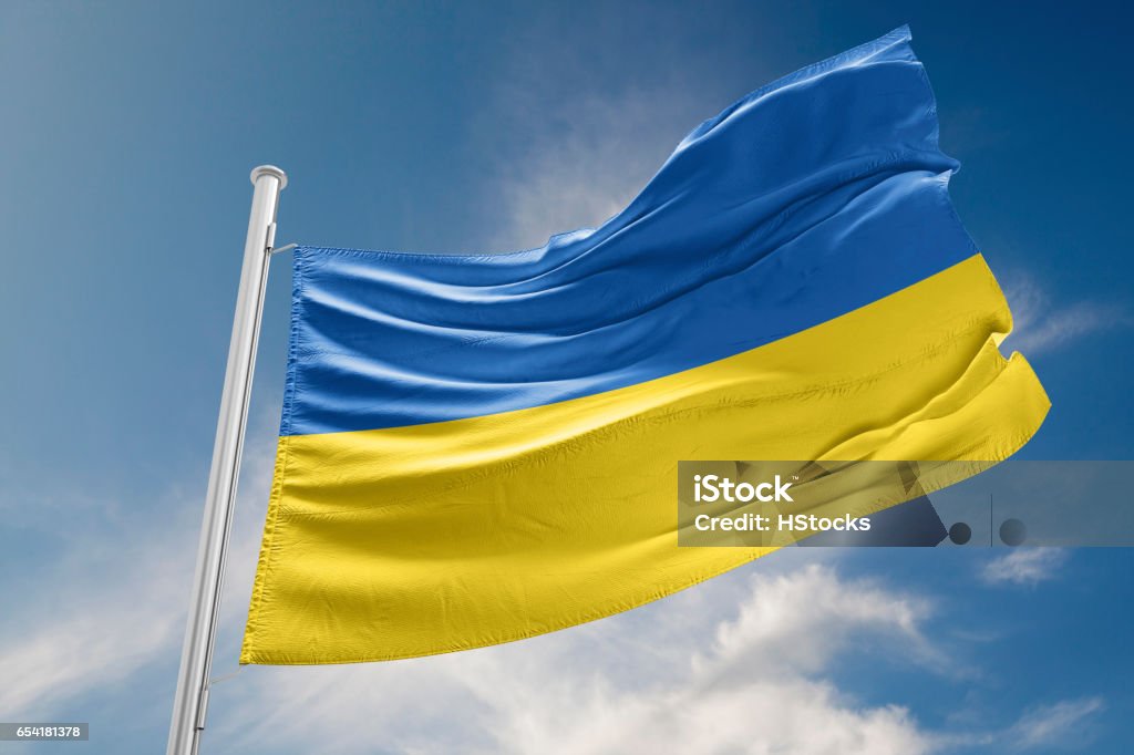 Ukrainian Flag is Waving Against Blue Sky Ukrainian flag is waving at a beautiful and peaceful sky in day time while sun is shining. 3D Rendering Ukraine Stock Photo